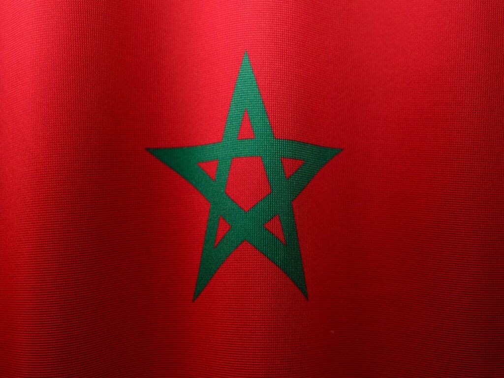 Detailed close-up of the Moroccan flag, highlighting its vibrant colors and iconic green star.