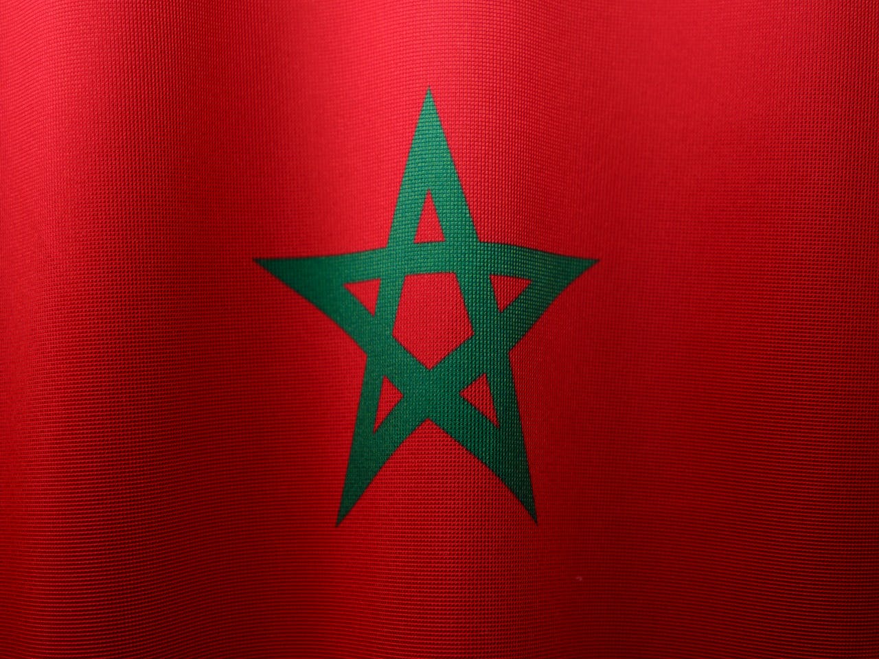 Detailed close-up of the Moroccan flag, highlighting its vibrant colors and iconic green star.